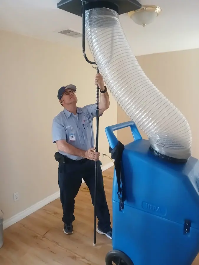 Furnace Tune-Up technician using HEPA equipment in Darien
